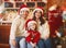 Warm young family getting ready for Christmas, sitting on sofa