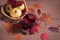 Warming drink mulled wine in a glass Cup on a dark wooden background with autumn leaves, viburnum berries