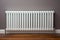 Warming Hands on White Radiator, Man Warms his Hand at Home, Cold Winter, Expensive Electricity Saving Concept,