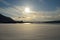 Warming sunrise over snowy field and mountain with cathedral and tromsoe city island and mainland