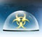Warning biohazard burning symbol under a glass dome