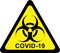 Warning biohazard sign with COVID-19 text