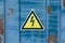 Warning elctrical triangle sign on yellow background or table