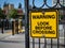 Warning look before crossing yellow warning sign at train station