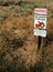 Warning Rattle Snakes Sign in natural prairie grassland