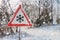 Warning road sign before ice break. Snowy road ad winter.