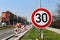 Warning  of the road works which are ahead limiting the speed to 30