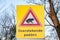 Warning sign against toads crossing the road