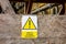 The warning sign Be more careful Dbejte zvysene bezpecnosti in Czech on a plywood wall informing about danger in hazardous area