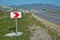 Warning sign and bend in road. Empty road . Winding road white and red sign in the mountains