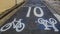 Warning sign for a cyclist to give way to pedestrians and speed limit, not over 10 km/h, it shows painted on the road.