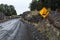 Warning sign for falling rocks on a unpaved road. Torres del Paine, Chile