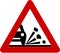 Warning sign with gravel on road