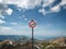 A warning sign with a high heel pictured on top of a mountain Swiss Alps with views of the mountain range, sky and clouds in