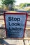 Warning sign at a level crossing warning pedestrians and drivers of potential danger from trains Wirral July 2013