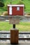 Warning sign on an old railroad station and a red shack in Canterbury region, New Zealand