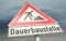 Warning sign: permanent building site in German: Dauerbaustelle