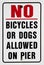 Warning sign prohibiting bicycles or dogs on pier