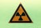 Warning sign radiation hazard in an orange triangle on a green background