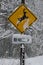 Warning sign on a road for the presence of sika deer during a snowfall
