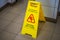 Warning sign with Russian text caution wet floor. Sign in the corridor of the office or entertainment center. Cleaning ceramic