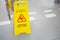 Warning sign with Russian text caution wet floor. A sign near the steps in an office or entertainment center. Cleaning ceramic