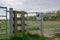 Warning sign seen attached to the entrance of metal farm gate, which has right of way for the public.