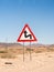 Warning sign sharp turns on the Namib desert, Namibia, Africa.