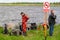 Warning sign on the shore of the technical reservoir with the inscription-Swimming is prohibited. In the background, diving work