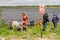 Warning sign on the shore of the technical reservoir with the inscription-Swimming is prohibited. In the background, diving work