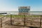 Warning sign on the shore. Text in Russian: the beach is not equipped. swimming is forbidden