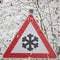 Warning sign shows danger of ice and snow at street