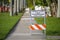 Warning sign that sidewalk is closed at street construction site. Utility work ahead