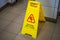 Warning sign with the text caution wet floor. Sign in the corridor of the office or entertainment center. Cleaning