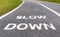 Warning sign to slow down marked on street, safety concept.