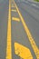 Warning sign of white and yellow color on road