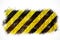 Warning sign yellow and black stripes painted over rusty metal plate as texture background isolated on white background