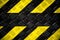 Warning sign yellow and black stripes painted on steel checker plate or diamond plate warning danger background