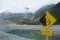 Warning signage of beware of falling rocks in New Zealand lake