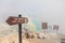 Warning signboard at wastelands in Kawah Ijen volcano crater at sulfur mine