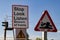 Warning signs at a level crossing warning pedestrians and drivers of potential danger from trains Wirral July 2013