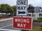 Warning, signs. One-way wrong way