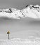 Warning sing on snowy ski slope and mountains in fog