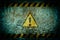 Warning symbol on dirty wall background with grunge and vignette