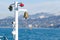 Warning system on the deck of ship - lamps of signal lights and the bronze bell against background of sea and mountains.