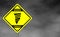 Warning tornado road sign . Yellow hazard warning sign against grey sky -