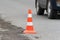 Warning traffic road cone standing on street asphalt city road during roadworks, road repairing, asphalt pavement works