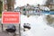 Warning Traffic Sign On Flooded Road