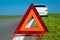 Warning triangle. Car breakdown on a country road. Malfunction of the car