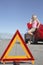 Warning Triangle With Woman On Call By Car On Road